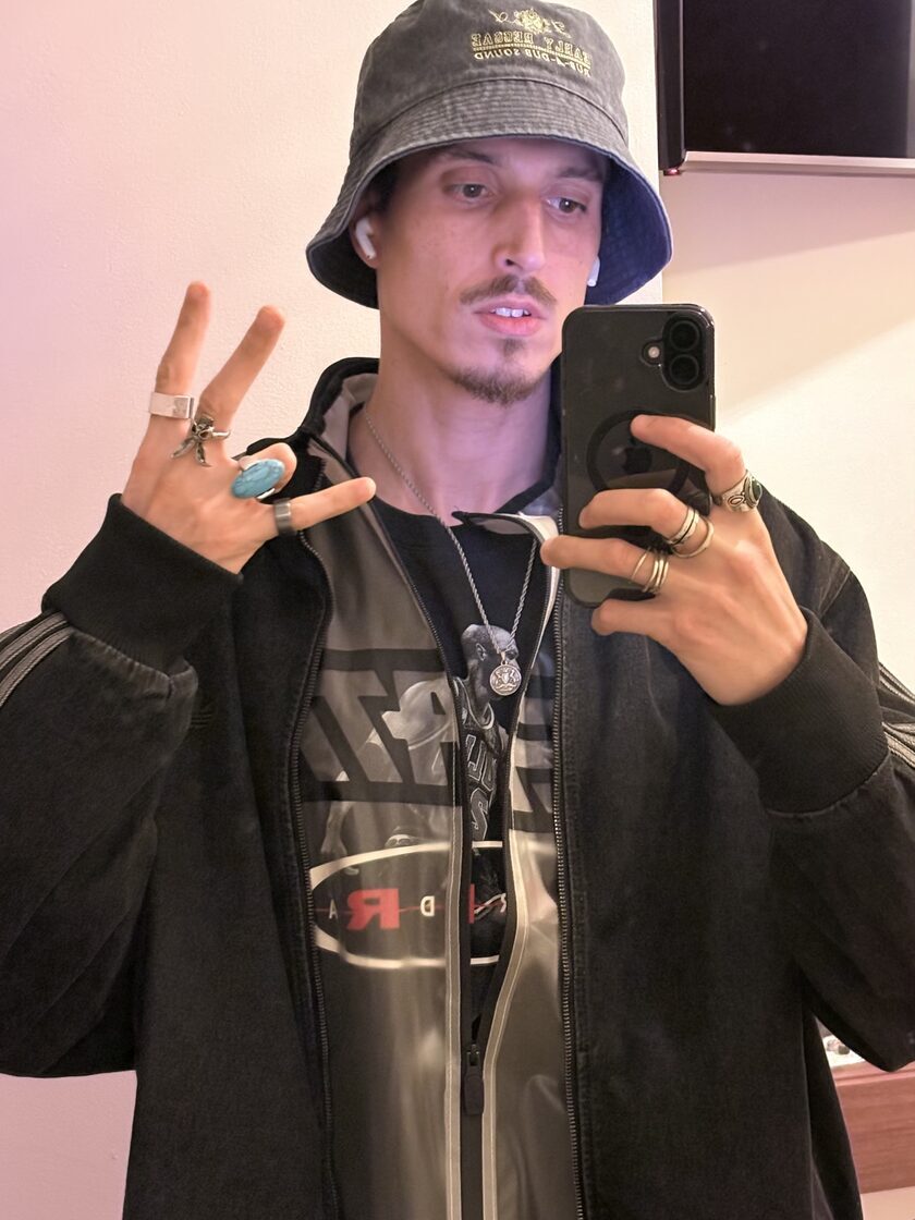 Bad upload example: a hat and phone add distractions around the face