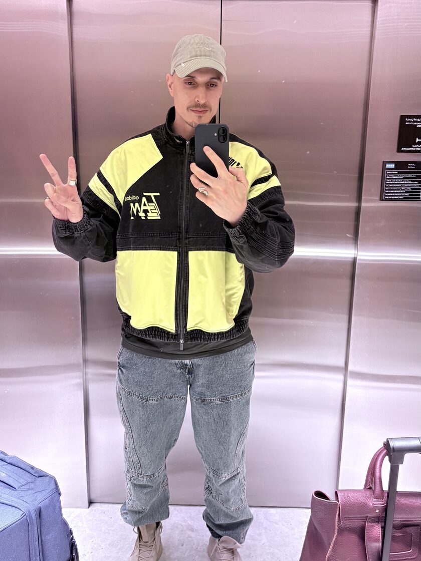 Bad upload example: clothing, luggage, and background overwhelm the face signal